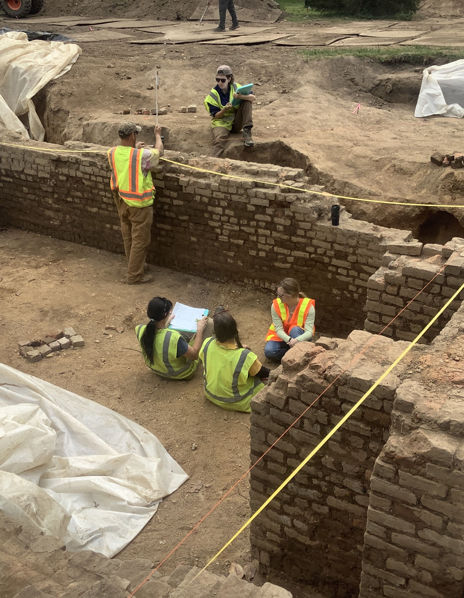 New South team members reviewing excavation of a foundation